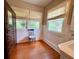 Comfortable bedroom boasts bright windows with views of lush landscaping at 501 Richmond St, Orlando, FL 32806
