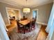 Formal dining room featuring a wooden table, chandelier, hardwood floors, and natural light at 501 Richmond St, Orlando, FL 32806