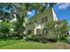Lovely two-story house with mature trees and landscaping, featuring a charming front porch and a well-manicured lawn at 501 Richmond St, Orlando, FL 32806