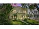 Charming home exterior with lush tropical landscaping and a beautiful brick walkway leading to the front door at 501 Richmond St, Orlando, FL 32806