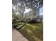 Stunning two-story home featuring lush landscaping and a well-manicured lawn, nestled under mature trees at 501 Richmond St, Orlando, FL 32806