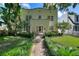 Charming two story home with lush front lawn, stone walkway, and well-manicured landscaping at 501 Richmond St, Orlando, FL 32806