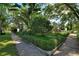 View of a manicured front yard with lush landscaping and mature trees at 501 Richmond St, Orlando, FL 32806