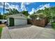 Exterior view of a detached garage with a paved driveway and a wooden fence at 501 Richmond St, Orlando, FL 32806