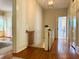 Inviting upstairs hallway featuring hardwood floors and access to a bright bathroom and bedroom at 501 Richmond St, Orlando, FL 32806