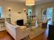 Bright living room featuring a brick fireplace, built-in shelving, hardwood floors, and comfortable seating at 501 Richmond St, Orlando, FL 32806