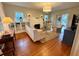 Bright living room featuring a fireplace, built-in bookshelves, hardwood floors, and comfortable seating area at 501 Richmond St, Orlando, FL 32806