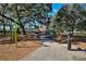 Colorful playground featuring slides, swings, and benches in a wooded setting at 501 Richmond St, Orlando, FL 32806
