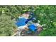 A vibrant playground with colorful equipment surrounded by mature trees, offering a fun and safe environment for children at 501 Richmond St, Orlando, FL 32806