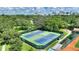 Overhead shot of the community tennis courts with players, surrounded by lush trees and greenery at 501 Richmond St, Orlando, FL 32806