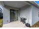 Covered back patio with sliding glass doors and a grill, perfect for outdoor entertaining at 5029 Grand Teton Ct, Deland, FL 32724