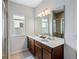 Bright bathroom featuring a double vanity, large mirror, and a glass-enclosed shower at 5029 Grand Teton Ct, Deland, FL 32724