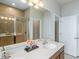 Bathroom featuring a single vanity, large mirror, shower, and linen closet at 5029 Grand Teton Ct, Deland, FL 32724