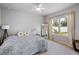 Bright bedroom with a ceiling fan, large window, and carpeted flooring for a cozy retreat at 5029 Grand Teton Ct, Deland, FL 32724