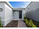 Inviting home entrance with a brick pathway, decorative plants, and a stylish black front door at 5029 Grand Teton Ct, Deland, FL 32724