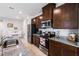Modern kitchen features stainless steel appliances, granite countertops, and dark wood cabinetry at 5029 Grand Teton Ct, Deland, FL 32724