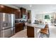 Spacious kitchen featuring stainless steel appliances, granite counters, and a convenient breakfast bar at 5029 Grand Teton Ct, Deland, FL 32724