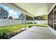 Green backyard featuring a covered patio, white vinyl fence, and well-manicured lawn at 5334 Cypress Dr, Winter Park, FL 32792