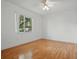 Bright bedroom with hardwood floors and a view of the outdoors, creating a serene and inviting space at 5334 Cypress Dr, Winter Park, FL 32792