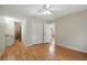 Spacious bedroom with hardwood floors, double closets, and an adjacent sink and vanity area at 5334 Cypress Dr, Winter Park, FL 32792