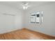 Minimalist bedroom with hardwood floors, ceiling fan, and a window view, creating a blank canvas for personalization at 5334 Cypress Dr, Winter Park, FL 32792