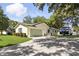 Home exterior with spacious driveway and green garage door, showcasing a well-maintained property at 5334 Cypress Dr, Winter Park, FL 32792