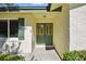 Inviting front entrance featuring a charming green double door with glass panels and a sidelight window at 5334 Cypress Dr, Winter Park, FL 32792