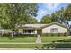 Charming single-story home featuring a well-manicured lawn and lush green landscaping at 5334 Cypress Dr, Winter Park, FL 32792