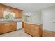 Kitchen with an island and wood cabinets, featuring granite countertops and a tile floor at 5334 Cypress Dr, Winter Park, FL 32792