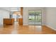 Hardwood floors in the living room with a view of the kitchen and enclosed patio at 5334 Cypress Dr, Winter Park, FL 32792