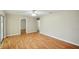 Spacious living room with hardwood floors, ceiling fan, and multiple doorways at 5334 Cypress Dr, Winter Park, FL 32792
