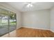 Bright sunroom with large sliding doors, a ceiling fan, and backyard views at 5334 Cypress Dr, Winter Park, FL 32792