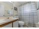 Bathroom with a single sink vanity, framed mirror, and shower with sliding glass door at 5439 E Sacramento Ct, Orlando, FL 32821
