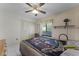 Bedroom featuring a ceiling fan, closet, window, and tile flooring at 5439 E Sacramento Ct, Orlando, FL 32821