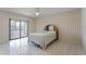 Bedroom with tile flooring, ceiling fan, sliding glass doors to the screened patio at 5439 E Sacramento Ct, Orlando, FL 32821
