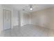 Spacious bedroom with ceiling fan, tile flooring, and ample closet space at 5439 E Sacramento Ct, Orlando, FL 32821