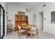 Cozy dining area featuring a chandelier, a wooden table with chairs, and a built-in display cabinet at 5439 E Sacramento Ct, Orlando, FL 32821