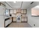 Classic kitchen features white appliances, tile floors, and a window for natural light at 5439 E Sacramento Ct, Orlando, FL 32821
