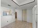 Bright kitchen area featuring tile flooring, storage closet, and view to an adjacent room at 5439 E Sacramento Ct, Orlando, FL 32821