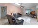 Bright living room featuring tile flooring, ceiling fan, skylights and comfortable leather seating at 5439 E Sacramento Ct, Orlando, FL 32821