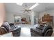Spacious living room with tile flooring, skylights, comfortable seating, and a view to the dining area at 5439 E Sacramento Ct, Orlando, FL 32821