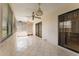 Bright sunroom featuring tile flooring, ceiling fans, and natural light from multiple windows at 5439 E Sacramento Ct, Orlando, FL 32821
