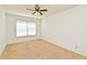 Clean bedroom with neutral carpet, a ceiling fan, and a window for natural light at 5588 Garden Grove Cir, Winter Park, FL 32792