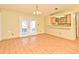Dining room featuring hardwood floors and access to the kitchen at 5588 Garden Grove Cir, Winter Park, FL 32792