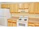Kitchen features wood cabinets, white stove and refrigerator, and laminate countertops at 5588 Garden Grove Cir, Winter Park, FL 32792