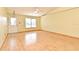 Living room with front door, window with blinds, and light-yellow painted walls with wood-look floors at 5588 Garden Grove Cir, Winter Park, FL 32792