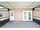Covered back patio with two doors and painted black trim at 5588 Garden Grove Cir, Winter Park, FL 32792