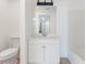 Bright bathroom features a white vanity with a mirror, toilet, and bathtub at 711 Sugar Bay Way # 109, Lake Mary, FL 32746