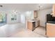 Open-concept living room and kitchen featuring tile floors, and a sliding glass door to the patio at 711 Sugar Bay Way # 109, Lake Mary, FL 32746