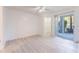 Bright main bedroom with a ceiling fan, tile floors, walk-in closet, and sliding door to patio at 711 Sugar Bay Way # 109, Lake Mary, FL 32746